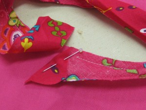 Fold binding at right angle and commence stitching over the fold.