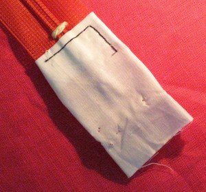 Folded piece of fabric used to cover cut end of zipper - stitch in place on one side