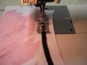 Stitch with tape uppermost. The feed teeth will ease the skirt in place.