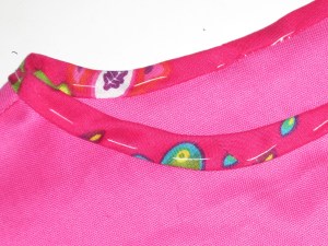 Turn binding at right angles to the seam line. Tack in place so it does not move or ripple.