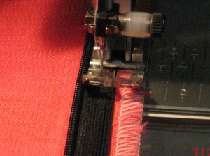 Position sewing foot against the teeth and machine baste in place.
