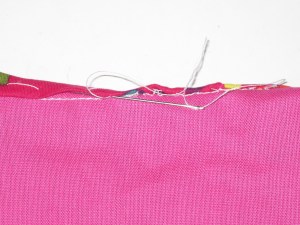 Roll folded edge back slightly. Hand stitch catching the bias just under the folded edge.