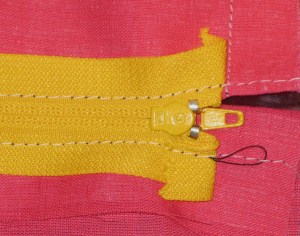 Fold top of tapes  back below level of seam line and stitch in place.