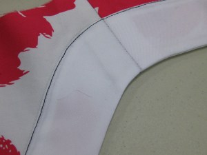 Facing is turned to right side and edge stitched in place. This is an alternative to a separate band. Seam allowance is invisible from underside of neck edge.
