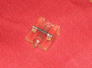 Invisible zipper foot from top and under side - note the grooves.