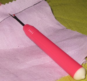 The way most sewists were taught to use an unpicker - slide the blade under and break the stitches.