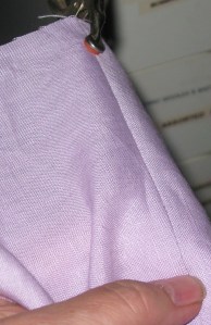 Clamp fabric and pull the seam to be unpicked until it is taut