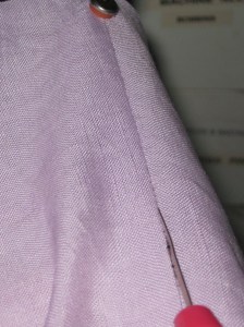 Insert red ball on the end of the unpicker between the stitches and push forward to open the seam.