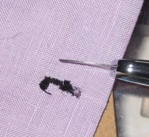 A buttonhole mess - gently and slowly pass the blade over the underside of the stitching